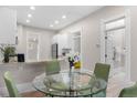 Eat-in kitchen featuring granite countertops, seating, and stainless steel appliances at 328 E Dakota Ave, Denver, CO 80209