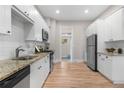 Spacious kitchen featuring stainless steel appliances, granite countertops, and hardwood floors at 328 E Dakota Ave, Denver, CO 80209