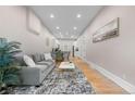 Bright living room features hardwood floors, modern decor, and a spacious layout at 328 E Dakota Ave, Denver, CO 80209