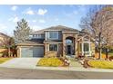 Beautifully landscaped home with a brick and siding exterior and a welcoming front entrance at 17076 W 71St Pl, Arvada, CO 80007