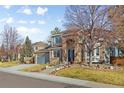 Attractive home featuring manicured landscaping, brick accents, and a spacious driveway at 17076 W 71St Pl, Arvada, CO 80007