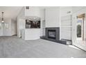Open-concept living room features fireplace, built-in shelving and access to a private balcony at 4286 S Eldridge St # 202, Morrison, CO 80465