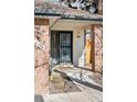 Inviting front door with brick columns, modern lighting, and clear property number at 6358 S Jackson St, Centennial, CO 80121