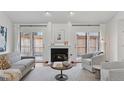 Cozy living room with fireplace, stylish furniture, and access to the backyard at 6358 S Jackson St, Centennial, CO 80121