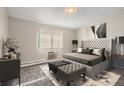 Serene main bedroom showcasing a tufted headboard, soft lighting, and comfortable furnishings at 720 S Clinton St # 2D, Denver, CO 80247