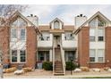 Brick and siding two-story townhome with dual chimneys and a private entrance at 3026 W Prentice Ave # H, Littleton, CO 80123