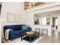 Inviting living room with a comfortable blue sofa, bright walls, and a modern aesthetic at 3026 W Prentice Ave # H, Littleton, CO 80123