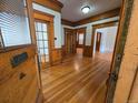 Inviting foyer featuring gleaming hardwood floors and beautiful wood trim throughout the home at 1453 Vine St, Denver, CO 80206