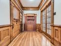 Spacious hallway featuring beautiful hardwood floors and ornate wood trim details, including a decorative fireplace at 1453 Vine St, Denver, CO 80206