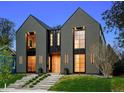Modern two-story home featuring large windows, striking architecture and landscaped yard at 2378 S Bannock St, Denver, CO 80223