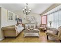 Elegant living room featuring tile floors, neutral furniture and a chandelier at 20651 E 42Nd Ave, Denver, CO 80249