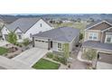 Aerial view of a single-Gathering home with landscaping in a neighborhood with mountain views in the distance at 9055 Swan River St, Littleton, CO 80125