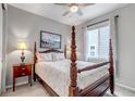 Primary bedroom featuring a four-poster bed, soft lighting, and comfortable decor at 9055 Swan River St, Littleton, CO 80125