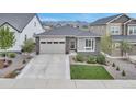 Beautiful single-Gathering home with stone accents, a well-manicured lawn, and a spacious driveway for convenient parking at 9055 Swan River St, Littleton, CO 80125