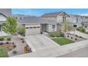Charming single Gathering home featuring a stone facade and a well-maintained front yard with professional landscaping at 9055 Swan River St, Littleton, CO 80125