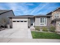 Beautiful single-story home featuring a landscaped front yard, stone accents, and a two-car attached garage at 9055 Swan River St, Littleton, CO 80125