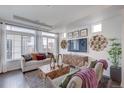 Bright living room featuring a modern design and large windows, offering ample natural light at 1176 Sugarloaf Ln, Erie, CO 80516
