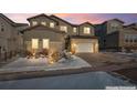 Two-story home with stone and siding accents, attached garage, and landscaping at 6922 Copper Sky Cir, Castle Pines, CO 80108