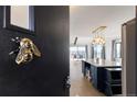 A stylish kitchen view through the door, featuring a large island with modern lighting at 7596 Rafter Rd, Franktown, CO 80116