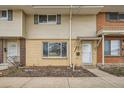 Charming townhouse featuring brick accents, neutral siding, and well-maintained landscaping at 9110 E Lehigh Ave, Denver, CO 80237