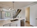 Bright, modern kitchen featuring quartz countertops, stainless steel appliances, and designer lighting at 1937 S Columbine St, Denver, CO 80210