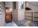Front door entrance to condo with security storm door, rock garden and secure fence at 6700 W 11Th Ave # 202, Lakewood, CO 80214