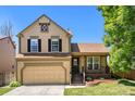 Traditional two-story home with an attached two-car garage and cozy front porch at 5310 E Manchester Dr, Castle Rock, CO 80104