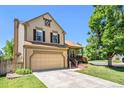 Inviting two-story home with a front porch, attached garage, and well-manicured lawn at 5310 E Manchester Dr, Castle Rock, CO 80104