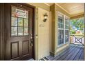 Close-up of a welcoming front door with a decorative welcome sign and sidelight window at 5310 E Manchester Dr, Castle Rock, CO 80104