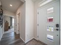 Bright entryway with wood floors and a door featuring decorative window panes at 21935 E 51St Dr, Aurora, CO 80019