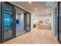 Bright foyer with light wood floors, modern art, and glass doors to outdoor patio at 651 Emberglow Ln, Highlands Ranch, CO 80126