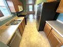 Functional kitchen featuring wood cabinets, stainless steel appliances, and neutral countertops at 55619 E 31St Ave, Strasburg, CO 80136