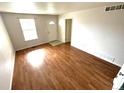 Inviting living room with a bright window, hardwood floors, and neutral paint at 55619 E 31St Ave, Strasburg, CO 80136