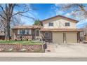 Traditional two-story home with a two-car garage, brick accents, and lovely landscaping at 4381 S Estes St, Littleton, CO 80123