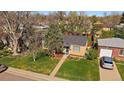 An elevated view of the house shows a well-maintained lawn, mature trees, and a detached one-car garage at 4530 S Pennsylvania St, Englewood, CO 80113