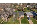 Birds eye view of the property showing manicured lawn, mature trees, detached garage, and neighborhood at 4530 S Pennsylvania St, Englewood, CO 80113