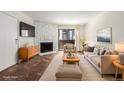 Inviting living room with stone fireplace and abundant natural light at 12047 E Harvard Ave # 103, Aurora, CO 80014