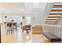 Bright and airy entryway with hardwood floors, stairs leading to the upper level, and an open floor plan at 5926 S Jellison St # B, Littleton, CO 80123