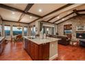 Modern kitchen with granite countertops, a center island, stainless steel appliances, and hardwood flooring with open layout to living area at 10693 Mountaingate Ct, Highlands Ranch, CO 80126