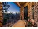 Private outdoor seating area with a stone surround, mountain views and wrought iron railings for the perfect sunrise at 10693 Mountaingate Ct, Highlands Ranch, CO 80126