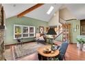 Spacious living room showcasing vaulted ceilings, skylight, and a cozy seating area at 29857 Park Village Dr, Evergreen, CO 80439