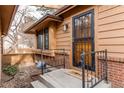 Charming front entrance with a secure black metal security door and landscaped entrance at 53 S Eagle Cir, Aurora, CO 80012