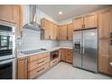 Modern kitchen featuring stainless steel appliances, quartz countertops, and subway tile backsplash at 7077 Ammons St, Arvada, CO 80004