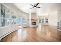 Bright living room with a cozy fireplace, hardwood floors and an abundance of natural light at 7077 Ammons St, Arvada, CO 80004