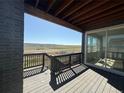 Relaxing covered deck featuring wood floors and railings, and expansive views at 8836 Whiteclover St, Littleton, CO 80125