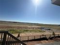 This property features a sweeping view of open land and a bright, sunny sky at 8836 Whiteclover St, Littleton, CO 80125