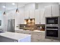Contemporary kitchen boasts sleek cabinetry, stainless steel appliances, and stylish backsplash at 2147 N Downing St, Denver, CO 80205