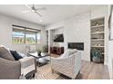 Comfortable living room features a modern fireplace, built-in shelving, and abundant natural light at 7950 Piney River Ave, Littleton, CO 80125