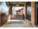 Relaxing front porch with a swing, perfect for enjoying the outdoors at 1453 S Lafayette St, Denver, CO 80210