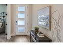 Welcoming entryway with a console table, art, a modern light fixture, and a view into the home at 2962 Newfound Lake Rd, Berthoud, CO 80513